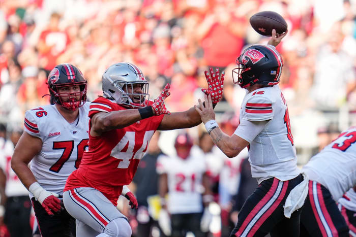 Sep 16, 2023; Columbus, Ohio, USA; Ohio State Buckeyes defensive end JT Tuimoloau (44) pressures Western Kentucky Hilltoppers quarterback Austin Reed (16) during the NCAA football game at Ohio Stadium. Ohio State won 63-10.